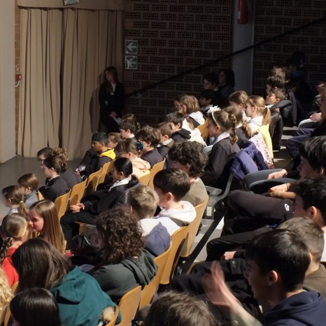 Studenti seduti in platea assistono a uno spettacolo
