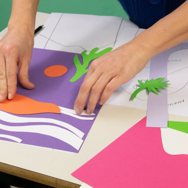 Mani che compongono un collage di carta colorata